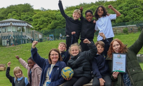 Students and staff at Hady Primary School celebrating with the OPAL Platinum Quality Mark certificate